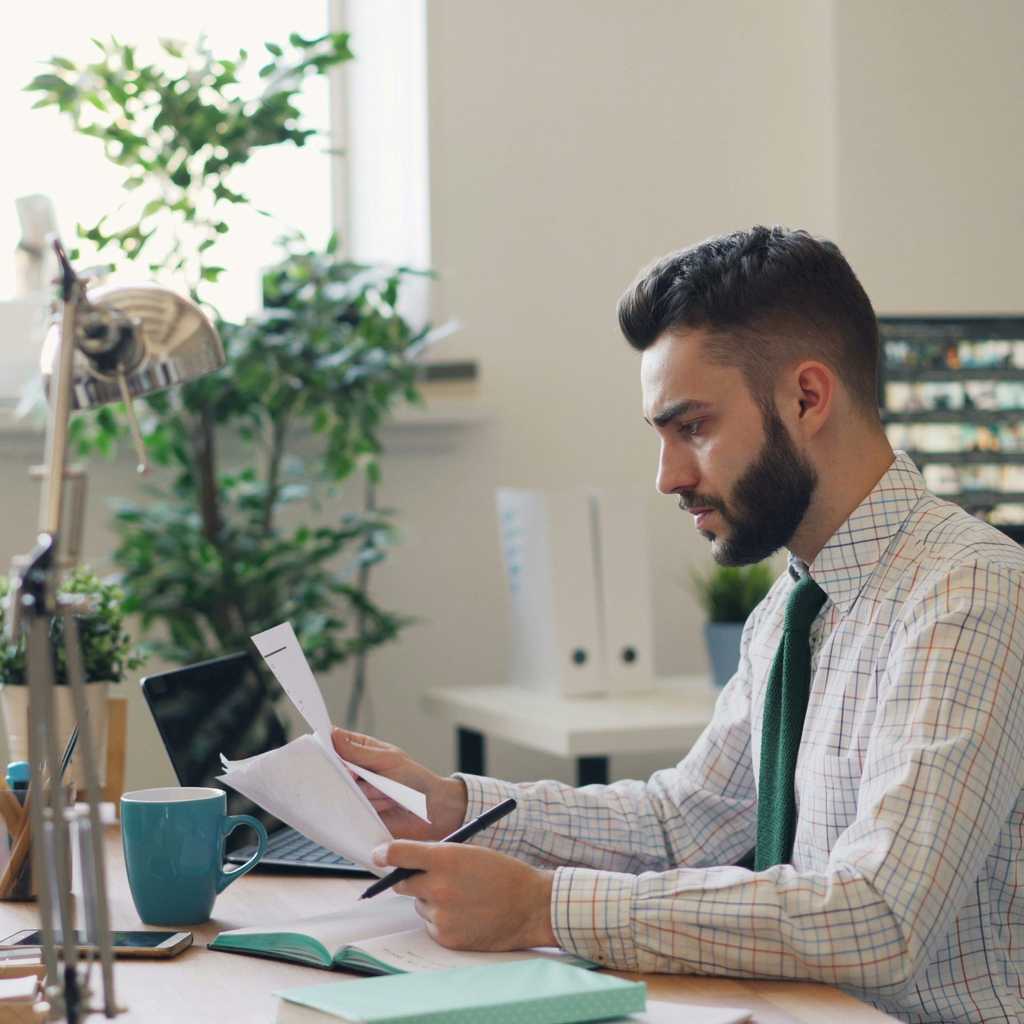 A person checking documents by the desk