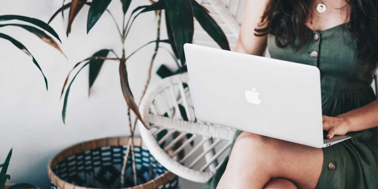 A Woman typing a laptop