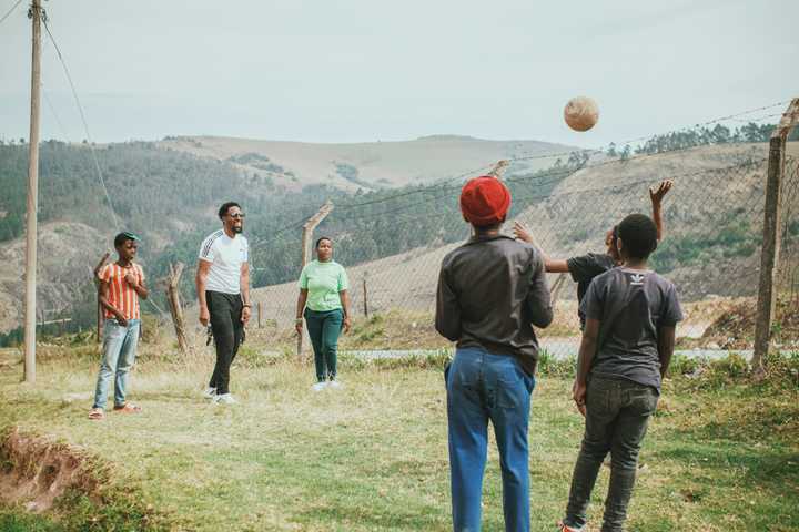 A familu playing football on a field